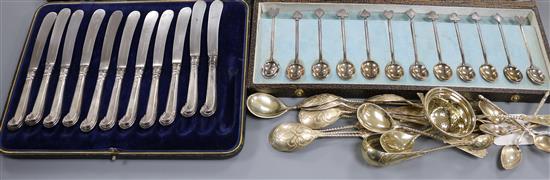 A set of six French 19th century gilt white metal coffee spoons, eleven 800 spoons and tongs, a cased set of silver teaspoons etc.